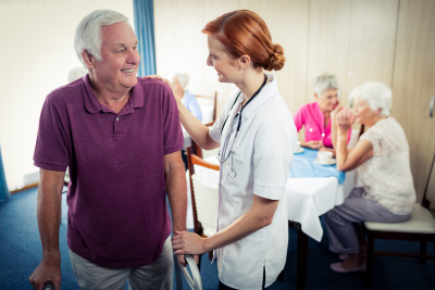 happy patient talking to woman nurse