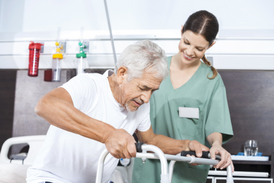 happy senior patient being assisted by happy female nurse